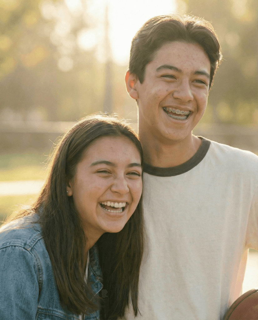 Two teenagers laughing together